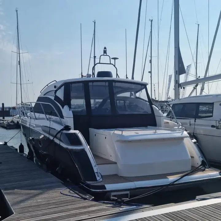 Glossy black sports yacht with deep reflection